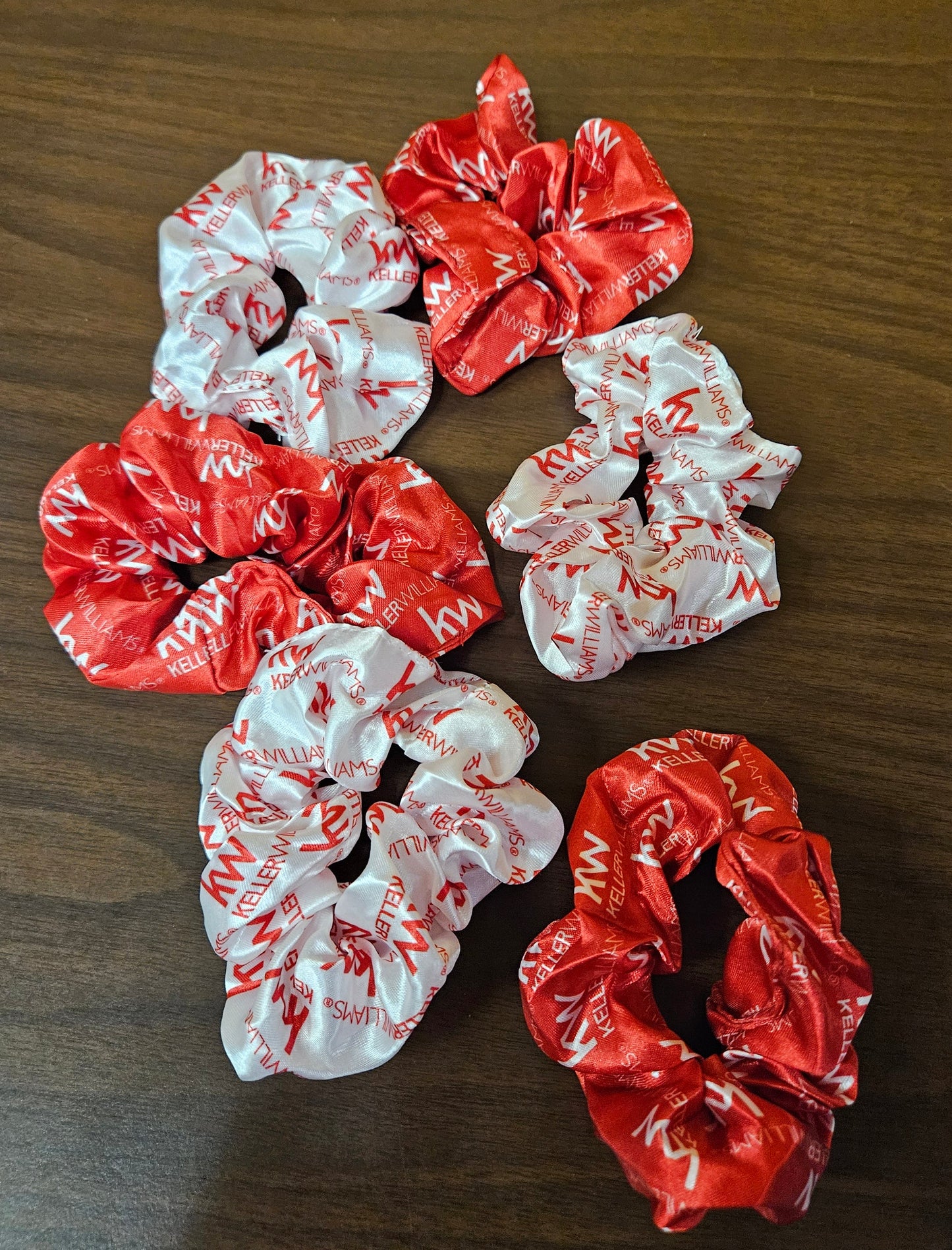 Red and white scrunchies on a wooden surface